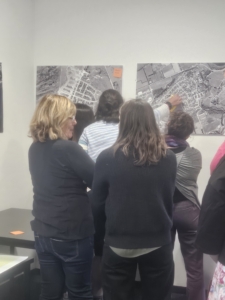 Participants of our meeting gather to put their post-it notes on images of current suburbs 